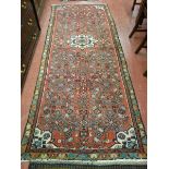 A PERSIAN HAMADAN RUNNER, red ground, 275 x 110 cms approximately