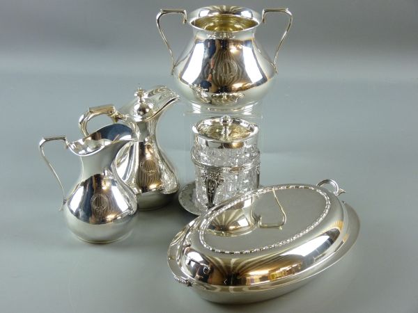 A GROUP OF PLATED TABLEWARE to include two jugs and a two handled pot for the Royal Goat Hotel,