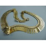 A NINE CARAT GOLD NECKLET in the Egyptian style, 23 grms