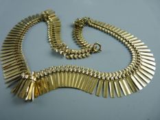 A NINE CARAT GOLD NECKLET in the Egyptian style, 23 grms