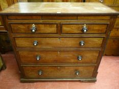 A GEORGIAN OAK & CROSSBANDED MAHOGANY CHEST of two short over three long drawers having turned ebony