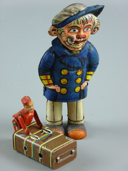 TWO TINPLATE CLOCKWORK MECHANICAL FIGURES including a Gescha Express Porter, German patent marks