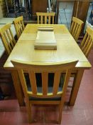 A DINING SUITE, a quality modern (four years old) light wood suite of draw leaf dining table with