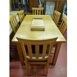 A DINING SUITE, a quality modern (four years old) light wood suite of draw leaf dining table with