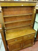 A VINTAGE OAK DRESSER having a three shelf Delft rack with shaped decoration on a moulded edge top