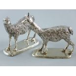 A PAIR OF STANDING LLAMA FIGURES, white metal with no visible markings on rectangular bases, 10 x 12