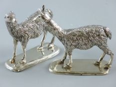 A PAIR OF STANDING LLAMA FIGURES, white metal with no visible markings on rectangular bases, 10 x 12