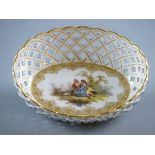 AN OVAL WHITE GROUND DRESDEN DISH with deep and delicate lattice work border and with gilt