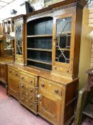 A GEORGIAN NORTH WALES OAK BREAKFRONT DRESSER with inverted stepped cornice and block pattern over a