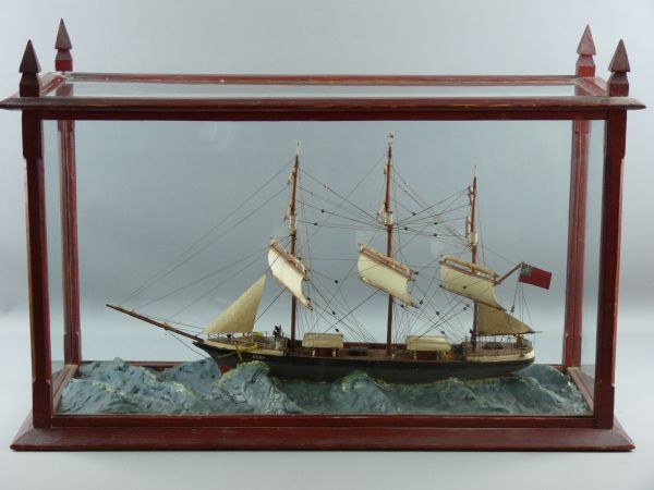 A CASED SHIP, the triplemaster 'Dora' depicted in heavy seas, in a pine case with glass panels all