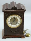 A CIRCA 1900 CARVED MAHOGANY MANTEL CLOCK, the shaped top case with leaf and floral front decoration