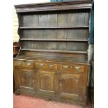 A LATE 18th/EARLY 19th CENTURY OAK DRESSER having a three shelf rack with shaped sides over a base