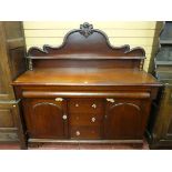 A LATE VICTORIAN MAHOGANY SIDEBOARD having a shaped rail back with turned pillars and with a long