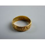 A GOLD WEDDING BAND, 4 grms with hearts and floral decoration