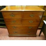 AN EDWARDIAN MAHOGANY CHEST of two short over three long drawers with pierced brass backplates and