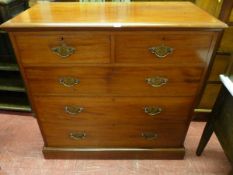 AN EDWARDIAN MAHOGANY CHEST of two short over three long drawers with pierced brass backplates and