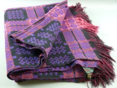 A WELSH WOOLLEN BLANKET, black and purple and with original label titled 'A Derw Product, Made in