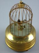 A SUNLEY BIRD AUTOMATON, a single caged bird with moving beak and tail feathers on a circular gilt