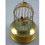 A SUNLEY BIRD AUTOMATON, a single caged bird with moving beak and tail feathers on a circular gilt