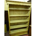 AN ANTIQUE STYLE PINE BOOKCASE with simple carved decoration, adjustable shelves and single lower