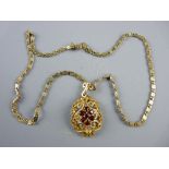 A BELIEVED NINE CARAT GOLD FIGARO CHAIN with garnet decorated star pendant, 5.5 grms