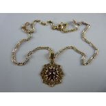 A YELLOW METAL ANTIQUE CHAIN WITH GARNET PENDANT, 9 grms gross