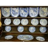 A WILLOW PATTERN DRESSER SET of six meat platters, fifteen dinner plates and a jug