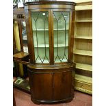 A REPRODUCTION MAHOGANY STANDING CORNER CABINET with twin glazed upper doors and bow front painted