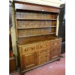 A MID 19th CENTURY OAK WELSH DRESSER with a three shelf rack over a base of two opening centre