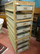 A PINE & WIREWORK EGG STORAGE RACK having eight sliding pull out drawers with brass label frames, 49