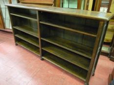 A SOLID OAK BOOKCASE with adjustable interior shelves, panel sided on bun feet and thick gauge