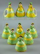 NINE CARLTONWARE NAPKIN RINGS all modelled as crinoline ladies, five with green dress, yellow ribbon