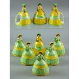 NINE CARLTONWARE NAPKIN RINGS all modelled as crinoline ladies, five with green dress, yellow ribbon