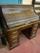 A 1920'S ROLL TOP DESK twin pedestal, polished with tambour lid, 126 x 122 cms