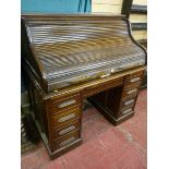 A 1920'S ROLL TOP DESK twin pedestal, polished with tambour lid, 126 x 122 cms