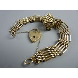 A NINE CARAT GOLD BRACELET, five bar with padlock and chain, 17 grms