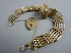 A NINE CARAT GOLD BRACELET, five bar with padlock and chain, 17 grms