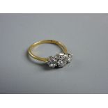 AN EIGHTEEN CARAT GOLD THREE STONE DIAMOND RING with a centre stone of visual estimate 0.5 carat,