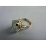 A NINE CARAT GOLD LADY'S DRESS RING with large oval light aquamarine stone, approximately 1.35 x 1