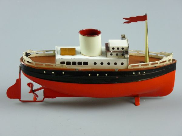 A CLOCKWORK TINPLATE LINER, a single funnel boat with red hull, marked 'Made in Germany' on the