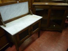 A MAHOGANY TWO DOOR BOOKCASE, late Victorian with simple carved corbel features, twin glazed doors