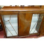 A MAHOGANY DISPLAY CABINET circa 1910, the railback top with carved shell adornment, central