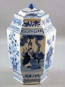 A CHINESE CERAMIC HEXAGONAL JAR & COVER in blue and white palette showing panels of an elder with