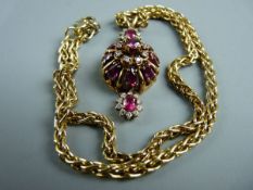 A FINE DIAMOND & RUBY ENCRUSTED CIRCULAR BASKET PENDANT having eight pear cut rubies with centre