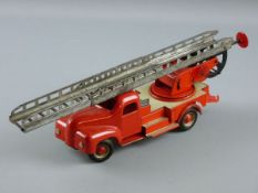 A CLOCKWORK TINPLATE FIRE ENGINE, red livery with front steering, two part extending ratchet ladder,