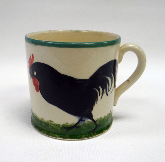 A RARE LLANELLY ‘COCK & HEN’ PATTERN MUG with a handle and painted with a single black hen