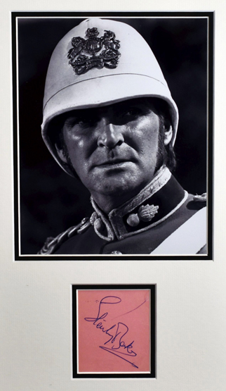 A STANLEY BAKER AUTOGRAPH framed as one with a black and white still photograph of the actor in