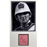 A STANLEY BAKER AUTOGRAPH framed as one with a black and white still photograph of the actor in