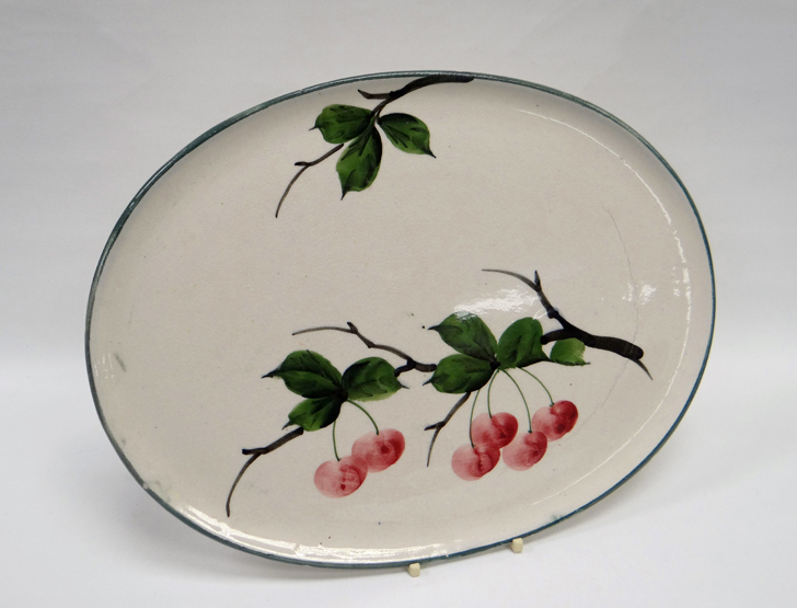 A LLANELLY POTTERY OVAL TRAY with painted cherries on branches, indistinct ‘LLANELLY’ printed mark