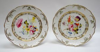 A PAIR OF SWANSEA PORCELAIN PLATES BY WILLIAM POLLARD having moulded borders with scrolls, flowers